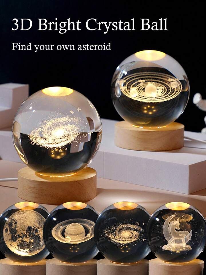 Set of 3D crystal balls with celestial designs on wooden bases.