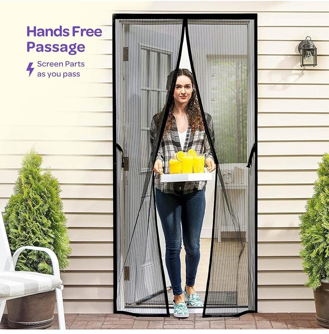 Woman using a hands-free magnetic screen door on a house exterior.